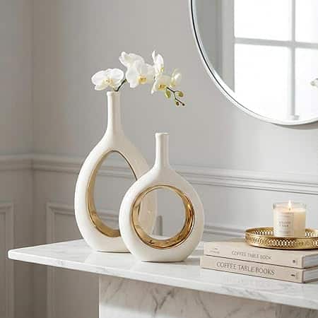 White and gold modern ceramic vases with minimalist circle and hollow‑ellipse shapes for home decor.