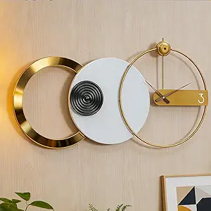 Mid‑century modern geometric wall clock with gold metal lines and a large abstract ring design.